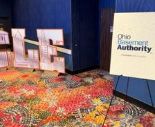 An Ohio Basement Authority sponsorship sign at the ESPN Draft Party 2026